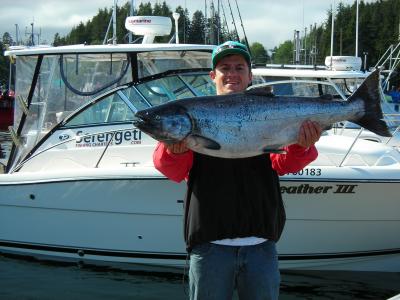 One of our clients with his huge Spring salmon..our gorgeous 33ft Pursuit in the background!